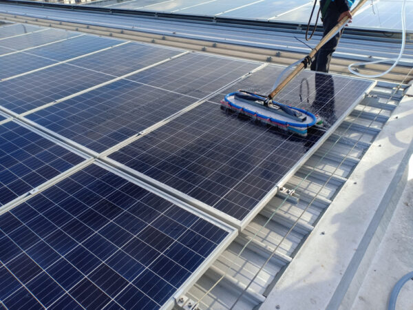 Man cleaning a solar panel