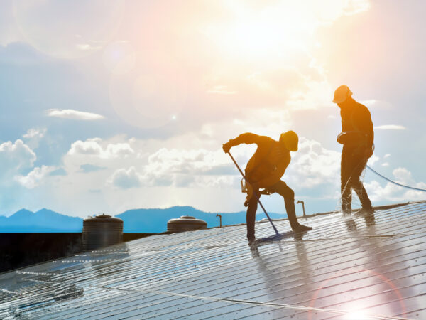 Technicians cleaning and maintaining a solar panel